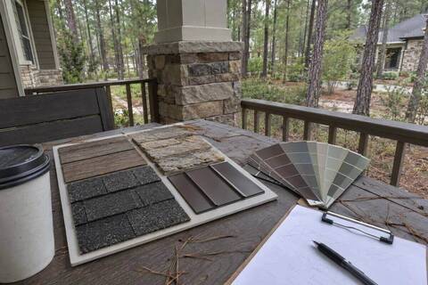 Roofing sample board and exterior color chips laid on a porch table